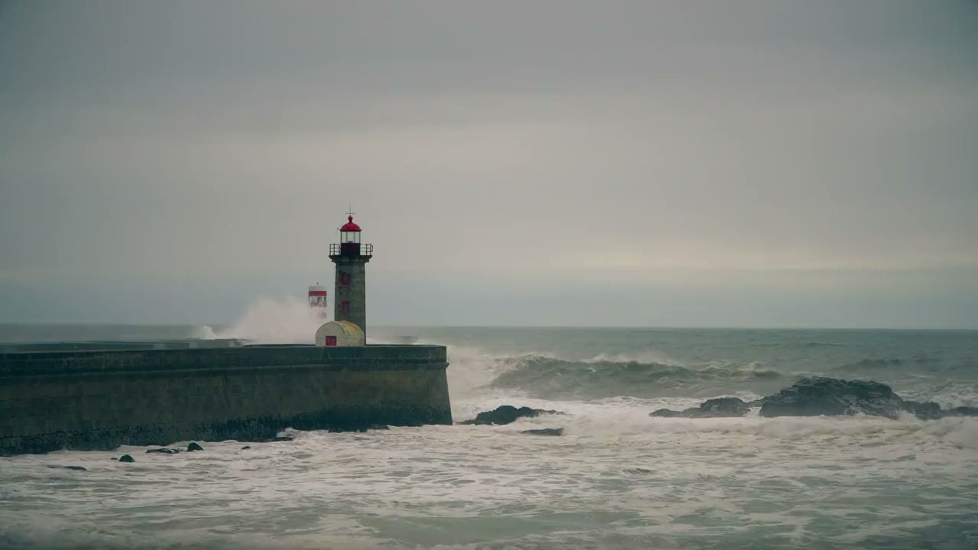 Lighthouse in storm surf