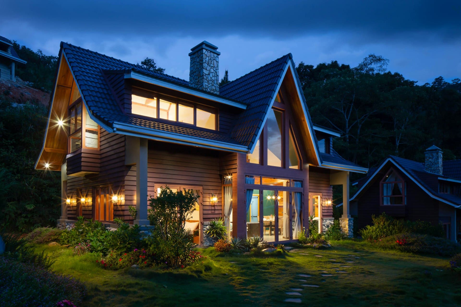 Gabled home with its lights on at blue hour